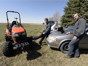 University of Regina industrial engineering students Caleb Friedrick, Sam Dietrich and Joshua Friedrick pose with their self-driving tractor.