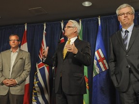 Premier Brad Wall (left) and former Manitoba premier Greg Selinger (right) at a 2010 conference in Vancouver. Wall had gracious words this week after Selinger's NDP government lost power after 16 years.