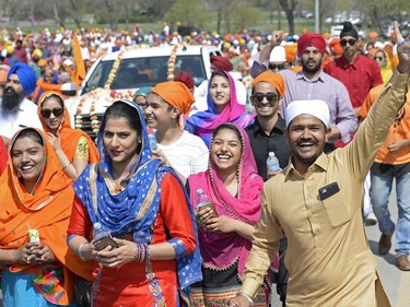 A man smiles and waves during Regina's first Sikh parade in Regina on Saturday.