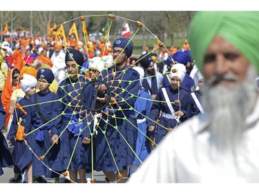 A man spins a wheel during a Sikh Day Parade in Regina, Sask. on Saturday May. 7, 2016. MICHAEL BELL