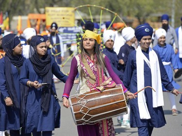 A woman drums during a Sikh Day Parade in Regina, Sask. on Saturday May. 7, 2016. MICHAEL BELL