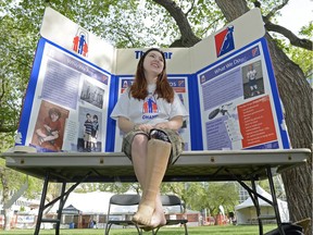 Angeline Ducharme sits in front of a War Amps display at the Saskatchewan Highland Gathering & Celtic Festival in Victoria Park in Regina on May 21, 2016.