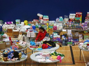 A woman picks through donated clothing and goods at a makeshift evacuee center in Lac la Biche, Alberta on May 5, after fleeing forest fires north of Fort McMurray.