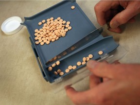 A pharmacist prepares to fill a prescription.