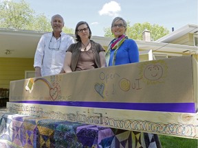Don Morris, Denise Seguin Horth and Sharon Pulvermacher stand behind a cremation container at a home funeral practicum in Regina, Sask. on Sunday May. 29, 2016. The personalized messages written on the container are an example of how a family might participate in the preparation of a home funeral. MICHAEL BELL