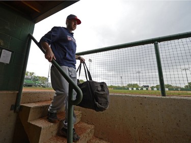 Head coach Mitch MacDonald brings equipment into the dugout during a Regina Red Sox training camp at Currie Field in Regina, Sask. on Monday May. 23, 2016.