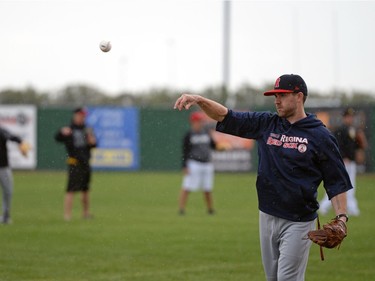 Head coach Mitch MacDonald throws while his team stretches ahead of a Regina Red Sox training camp at Currie Field in Regina, Sask. on Monday May. 23, 2016.