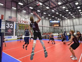 Jesse Wolthuis (16) of the NAVC Black Griffins spikes the ball against the WinMan Volleyball Club during the Division 1 boys final at the Volleyball Canada under-15 western championship on Monday. The Black Griffins won the match.