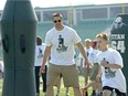 Justin Capicciotti coaches up one of the young football players at Don Narcisse's All-star Football Camp on Saturday.