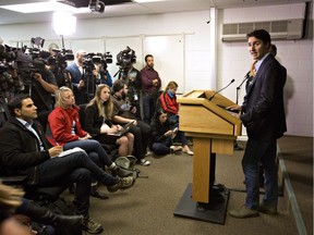 Prime Minister Justin Trudeau speaks with media in Edmonton, Alta., on Friday, after a visit to the devastated area of Fort McMurray. Trudeau announced the government is extending employment insurance benefits to three western economic regions that were left out when changes were first made.