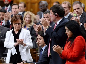 Prime Minister Justin Trudeau, centre, is applauded by members of the Liberal party after apologizing for his conduct following an incident when he pulled Conservative whip Gord Brown through a clutch of New Democrat MPs to hurry up a vote related to doctor-assisted dying.