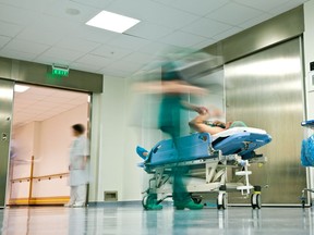 Local Input~ Blurred figures of people with medical uniforms transporting a patient to surgery     /   //  **CLEARED FOR ALL POSTMEDIA USE**   UNDATED --  hospital patient bed  CREDIT: FOTOLIA (**CLEARED FOR ALL POSTMEDIA USE**  STOCK PHOTO AGENCY IMAGE, ROYALTY FREE )/pws  // 0918 na mederrors ORG XMIT: POS1409181539363931