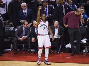 Toronto Raptors guard Kyle Lowry (7) reacts from the bench in the final minute of the game while playing against the Miami Heat during second half round two NBA basketball playoff action in Toronto on Sunday, May 15, 2016. The Raptors beat the Heat 116-89 to win the series in seven games.