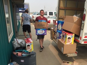 Hayden Soderlund smiles as he helps transport donations in Macklin, Sk.