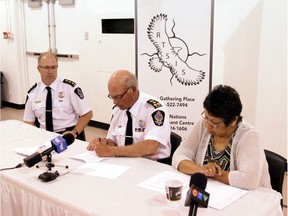 Deputy Police Chief Dean Rae looks on as Police Chief Troy Hagen (Centre) signs a protocol agreement with the File Hills Qu'Appelle Tribal Council after FHQTC Vice-Chair Elaine Chicoosealso signed the document. Monday at the Regina Treaty/Status Indian Service Centre. (photo supplied by FHQTC)