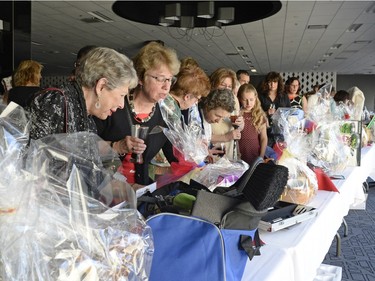 People peruse the silent auction items during Jabula!, a Grandmothers 4 Grandmothers Regina fundraiser supporting the Stephen Lewis Foundation held at Queensbury Convention Centre in Regina, Sask. on Saturday April. 30, 2016.