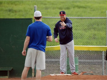 Pitching coach Cory Carter gives a pitcher instruction at a Regina Red Sox training camp at Currie Field in Regina, Sask. on Monday May. 23, 2016.