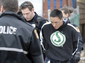 Members of the Regina Police Service take Anthony Joseph Slippery into custody in April 2012.