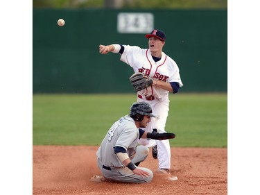 Regina Red Sox second baseman Derek Slate (8) throws to first base after getting Weyburn Beavers outfielder Dan Moro (24) during a game at Currie Field in Regina, Sask. on Sunday May. 29, 2016.