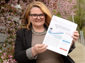 Elita Paterson, public representative on the Saskatchewan Maternal Mental Health Implementation Committee, holds up a sample of the petition that was presented to Rural and Remote Health Minister Greg Ottenbreit last week. The petition calls on the province to add the Edinburgh Postnatal Depression Scale to the provincial electronic checklist so doctors and other health-care workers can screen pregnant women for depression and anxiety.