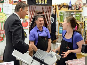 REGINA, SASK :  May 10, 2016  --  Quebec Conservative MP Maxime Bernier, from left, speaks with Carlo Giambattista and his daughter Marina as he visits the Italian Star Deli in Regina on Tuesday. TROY FLEECE