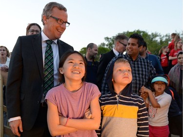 Premier Brad Wall  , left, was on hand for the ceremonial removal of the cover on the dome of the Legislative Building in Regina on Monday. TROY FLEECE