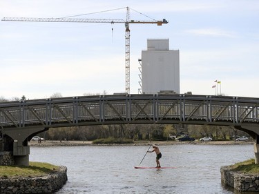 A standup paddle boarder makes his way around Wascana Lake in Regina on Monday.