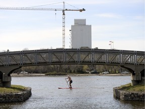 In Monday's warm weather, a standup paddleboarder makes his way around Wascana Lake.