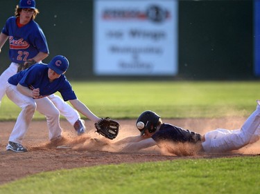 Denny Slough, left, of the Lumsden Cubs doesn't get the ball in time as Jimmy Smith of the Regina Buffalo slides safely into second base during Saskatchewan Premier Baseball League midget AA at Currie field in Regina on Tuesday.