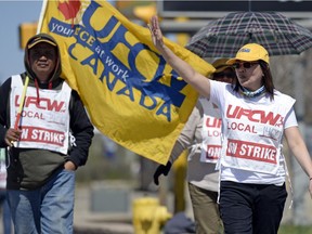 Girlie Basco, right, walks the UFCW picket line in front of the Best Western Seven Oaks hotel.