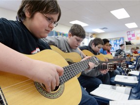 REGINA, SK: FEBRUARY 12, 2014 – Thomas Hartnell (L) and his grade 6 & 7 classmates at École St. Andrew play guitars in teacher Stephanie Gogal's class in Regina on February 12, 2014.   (Don Healy / Leader-Post) (Stand Alone Photo) (ENTERPRISE)