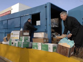 Former Saskatchewan information and privacy commissioner Gary Dickson (right) helps recover medical files from a recycling bin south of the Golden Mile mall in 2011.