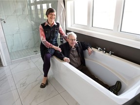 Don & Cyndy Findlay from Regina, winners of the Hospitals of Regina Foundation $1.5 million grand prize showhome + $10,000 cash shown checking out the bathroom off the master bedroom.