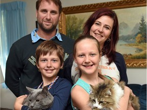 Jerry and Brenda Muir and their two kids Draven (L) holding Max and Brooklyn (R) holding  Ruby.  The Muir family recently fled Fort McMurray in a scary drive to Regina.