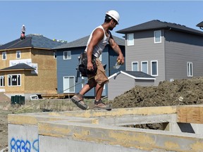 Kiley Long with Pacesetter Homes measures a basement wall in the Edgewater subdivision in northwest Regina. Regina home builders started construction on 88 housing units in April, down 25 per cent from 117 in April 2015, according to Canada Mortgage and Housing Corp.
