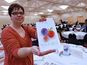 Souls Harbour Rescue Mission (SHRM) Marketing Manager Patty Humphreys with a handmade personalized thank you card to their sponsors for the 13th Annual Love You Neighbour fundraising banquet being held at the Delta Hotel in Regina.