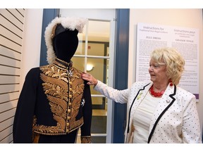 Lieutenant Governor Vaughn Solomon Schofield looks over the Windsor uniform of former Lieutenant Governor, Sir Richard Lake during Our Stories: Artifacts Tell All exhibit celebrating the 125th anniversary of Government House in Saskatchewan.
