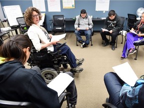 Instructor Cindy Leggott (C) talks to students at the Youth Employment Readiness Program at the Regina Work Preparation Centre.