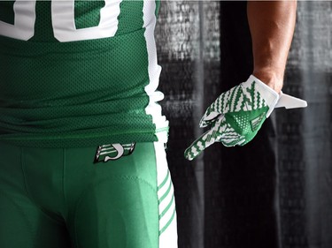 Spencer Moore points to the leg stripes at the launch of the new Saskatchewan Roughriders adidas uniforms for the 2016 season. The black trim was removed from the jersey and the numbers and the pants feature four stripes on the left side – each one representing a Grey Cup victory over the years.