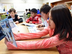 Brook-Lynn Pelletier in grade six at Imperial Community School reads book received from the Indigo Love of Reading Foundation for some new books for the school.