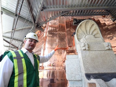 PCL's Jerrod Keuler, project manager for Saskatchewan Legislature Dome Renewal  beside the refurbished dome.  The project has used 12,700 kilograms of copper, worth $100,000 while the entire restoration project cost is approximately $21 million.