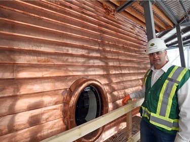 PCL's Jerrod Keuler, project manager for Saskatchewan Legislature Dome Renewal  beside a dormer window.  The project has used 12,700 kilograms of copper, worth $100,000 while the entire restoration project cost is approximately $21 million.