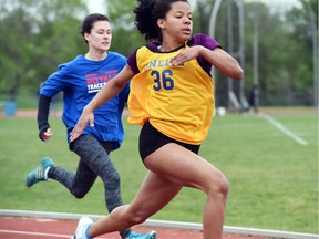 Savannah Buchholz, right, of O’Neill and Riffel’s Sydney Driven compete in a junior girls 100-metre heat Wednesday at the Regina High Schools Athletic Association track and field championships, held at the Canada Games Athletics Complex.