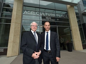 Michael Hoffort (R), president and CEO of Farm Credit Canada, the main tenant of Agriculture Place at 1820 Hamilton Street and Paul Hill, president and CEO of The Hill Companies, which developed the project talk at the grand opening of the building.