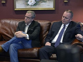 Premier Brad Wall and Finance Minister Kevin Doherty watch the federal budget on TV in Regina in March. Today, Doherty will deliver the Wall government's budget.