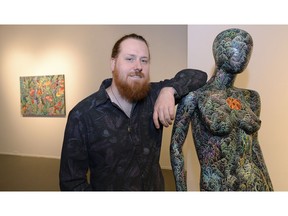 Artist Greg Allen with pieces from his art showcase at the Fifth Parallel Gallery at the U of R.