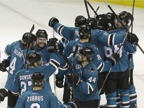 San Jose Sharks players celebrate after beating the St. Louis Blues in Game 6 of the NHL's Western Conference final Wednesday. San Jose is headed to the Stanley Cup final for the first time in franchise history.