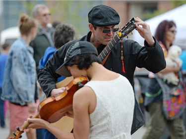 Tim Mrazek and Helen Chang tune their instruments at the Cathedral Village Arts Festival on 13th Ave. in Regina, Sask. on Saturday May. 28, 2016.