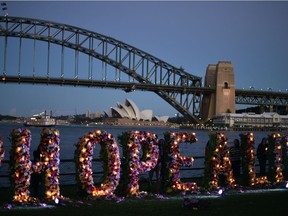 Amnesty International at 55: a section of a floral sculpture that reads "keep hope alive" is seen during a vigil in Sydney.