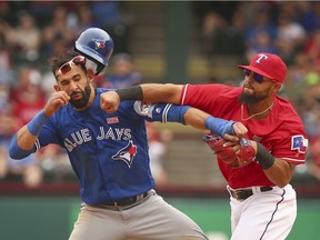 Toronto Blue Jays' Jose Bautista (left) gets punched by Texas Rangers second baseman Rougned Odor during the teams' recent brawl. The punch gives new meaning to "The Shot Heard 'Round the World" in baseball parlance.